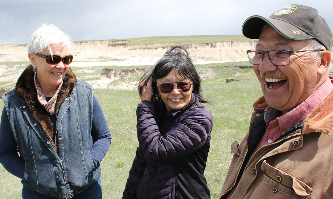 Three people laughing outside in Chadron